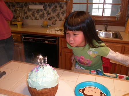 Kasen blowing out candles on Girl Cake
